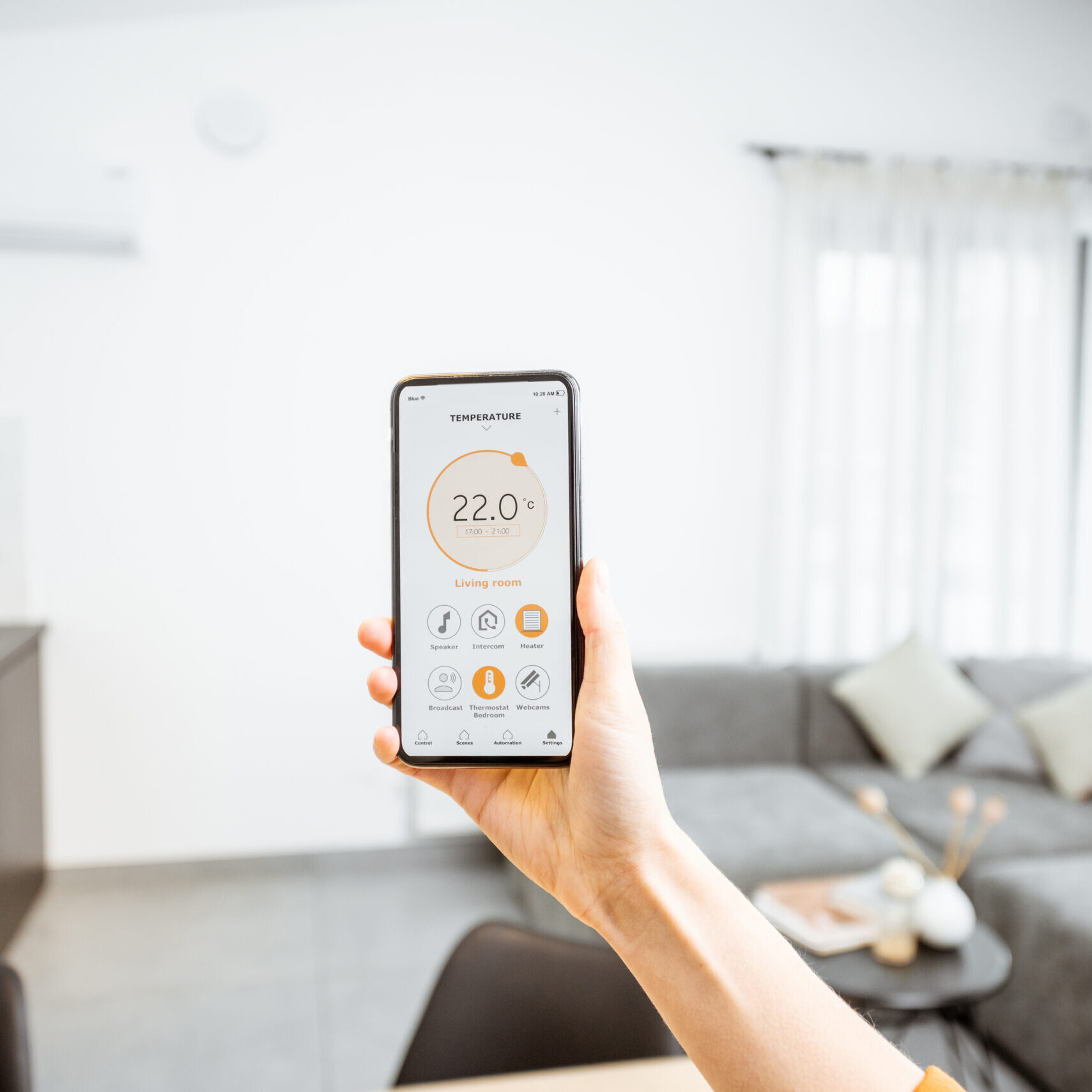 Controlling home heating temperature with a smart home, close-up on phone. Concept of a smart home and mobile application for managing smart devices at home